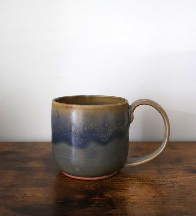 Hand-thrown mug with blue and sand drip glaze